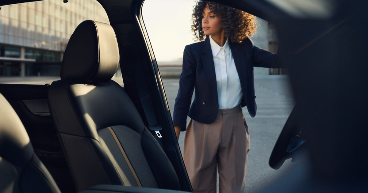 Mazda CX-90 black leather interior with driver entering vehicle