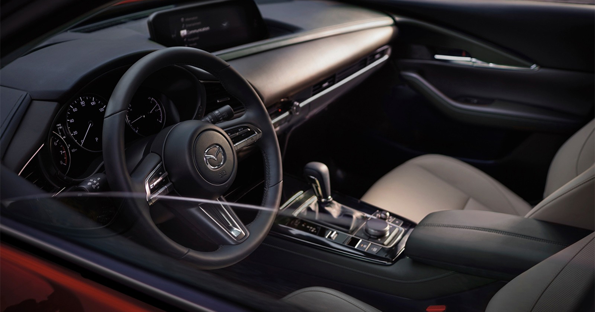 Mazda CX-30 black interior with steering wheel, dashboard, and infotainment