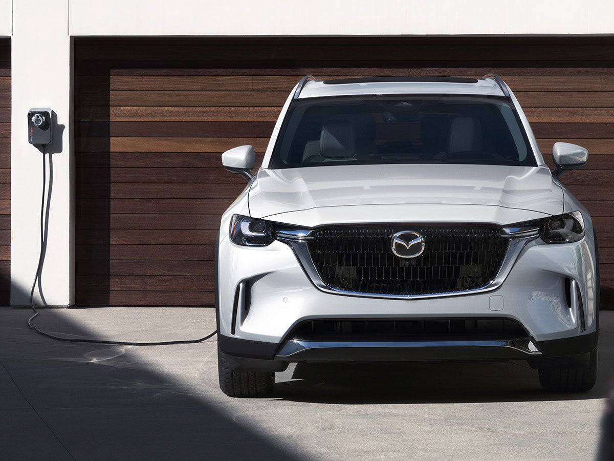 A stylish Mazda SUV running on road.